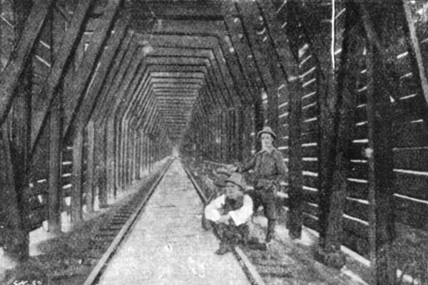 WE HAD TO RIDE ON SLEEPERS THROUGH FORTY-THREE MILES OF
SNOW SHEDS&mdash;THIS SORT OF THING.