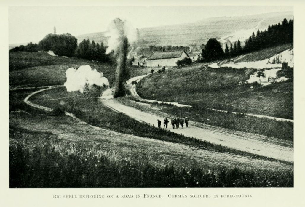 Big shell exploding on a road in France. German
soldiers in foreground.