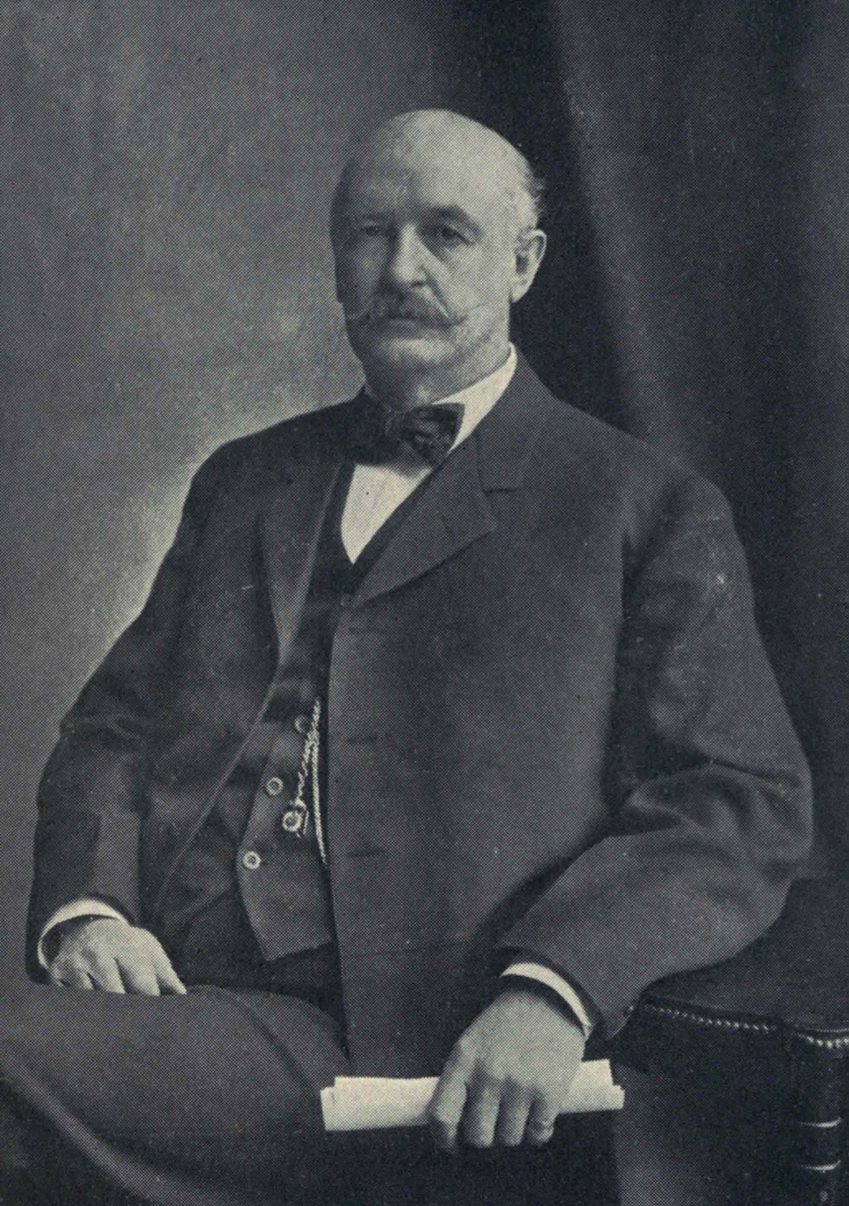 A formal
portrait of David Patterson Hatch, seated in a suit with bow tie,
holding a rolled paper.