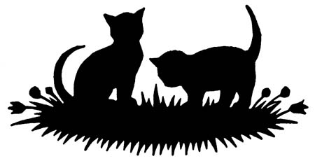 Two cats lounging in the grass