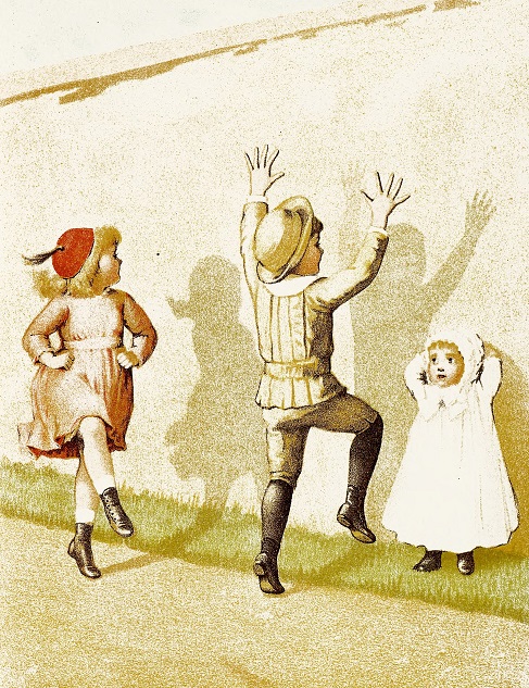 Children dancing making shadows on a wall